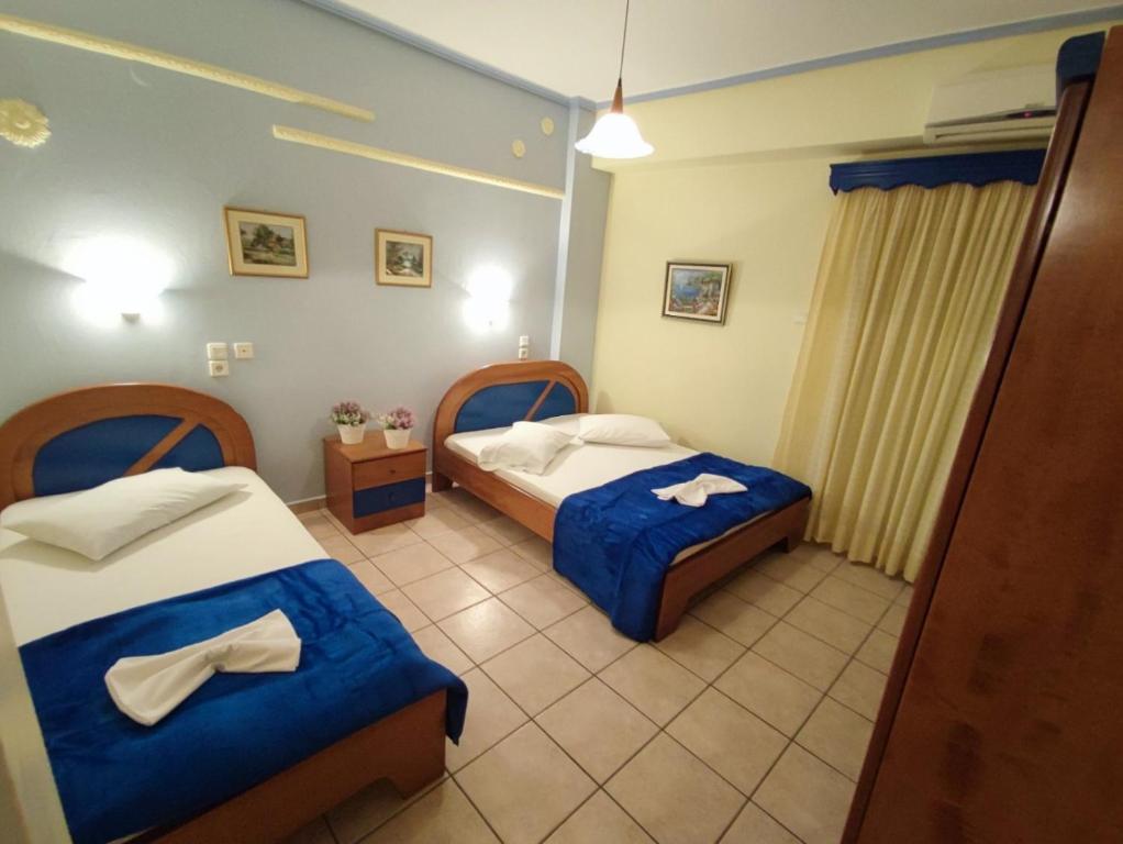 a hotel room with two beds in a room at Studios Dafni in Paralia Katerinis