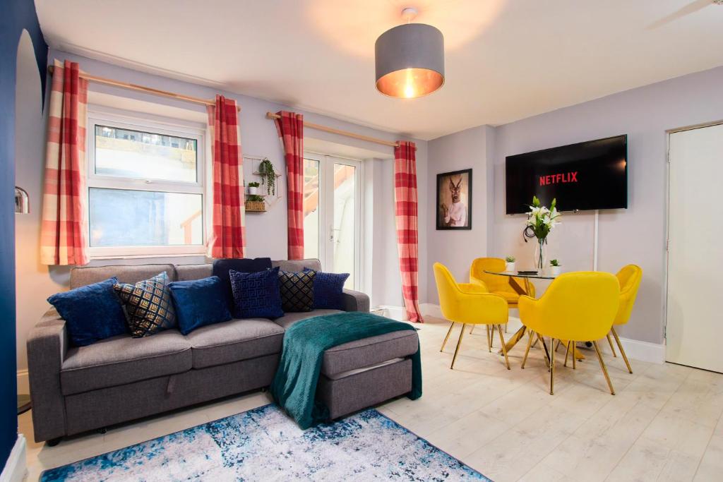 a living room with a couch and a table and chairs at Stylish 2 BR in Clifton - Garden in Bristol