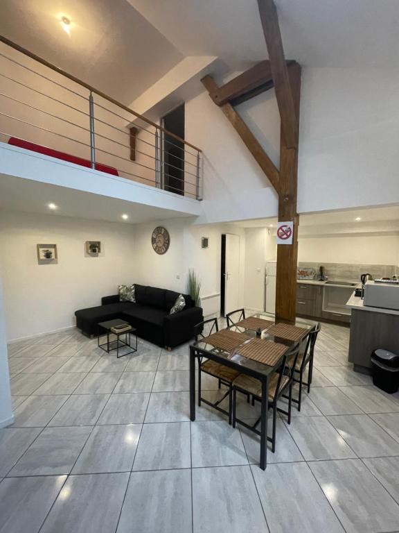 a living room with a couch and a table at Le Familiale climatisé & Wi-fi in Paroy-sur-Tholon