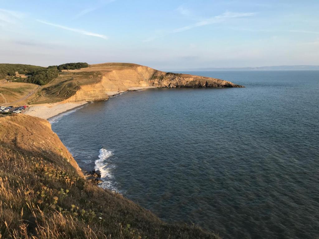 an island in the middle of a body of water at Woodlands Coastal Apartment in Southerndown