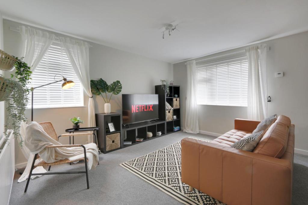 a living room with a couch and a tv at Springvale in Sheffield