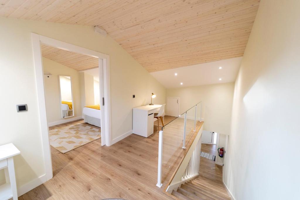 a room with a staircase leading to a bedroom at Apartamentos San Lazaro in Santiago de Compostela