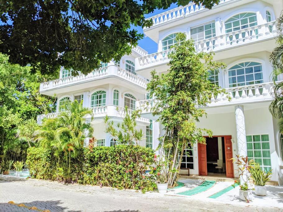 a large white house with trees in front of it at 18br up to 50guest Castillos Playacar walk to Beach and 5th Ave 1000Mbps in Playa del Carmen