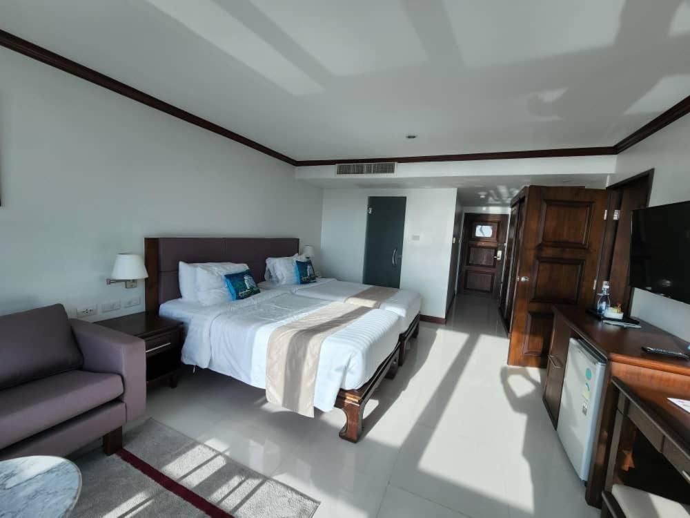 a bedroom with a bed and a couch and a television at Andaman sea view private in Patong Beach