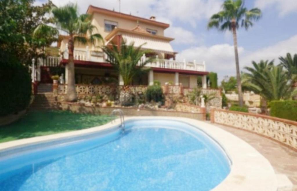 a swimming pool in front of a house at Bella Vista House in Chiva