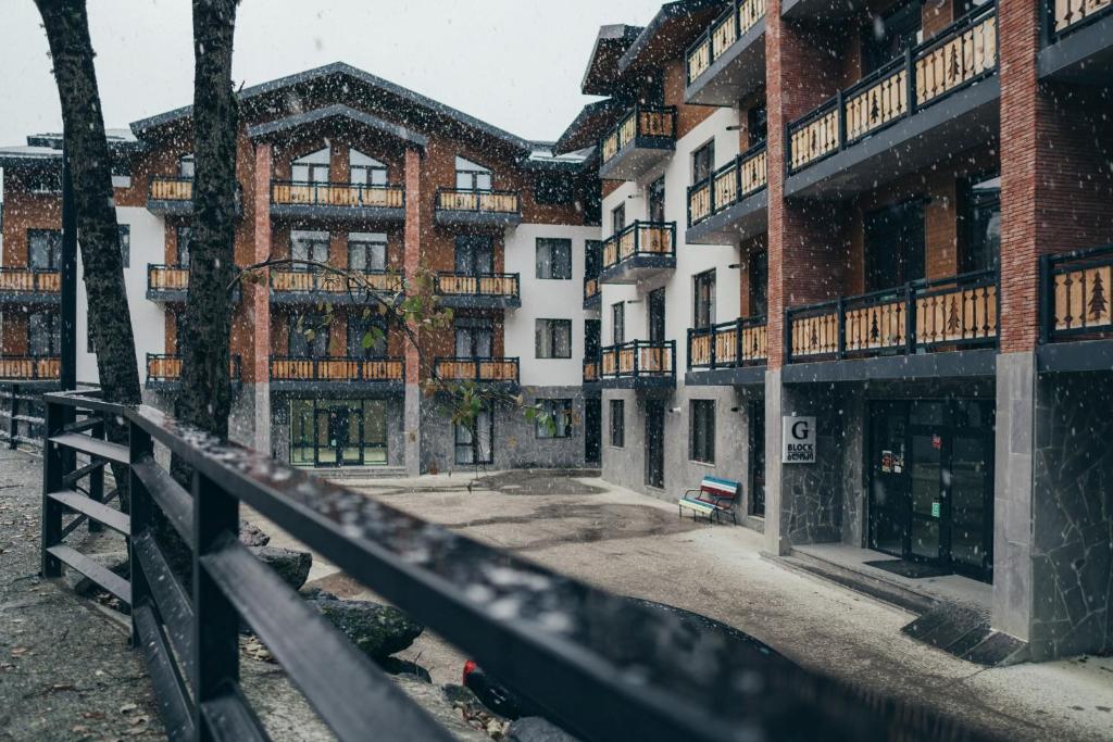 an empty street in front of a building at Zarku Apartments in Bakuriani