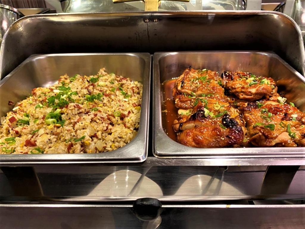 two metal trays of food with chicken and rice at Link World Hotel in Taipei