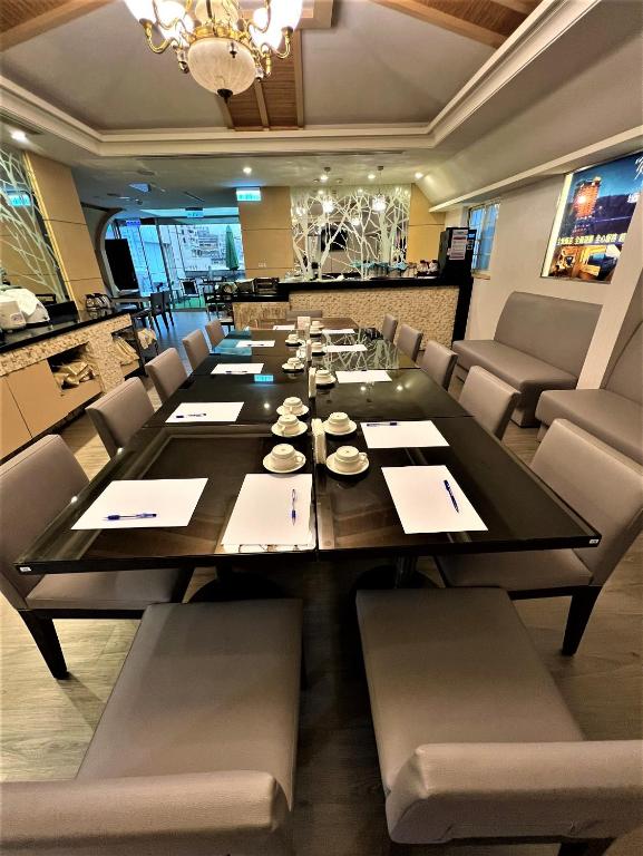 a dining room with a long table and chairs at Link World Hotel in Taipei