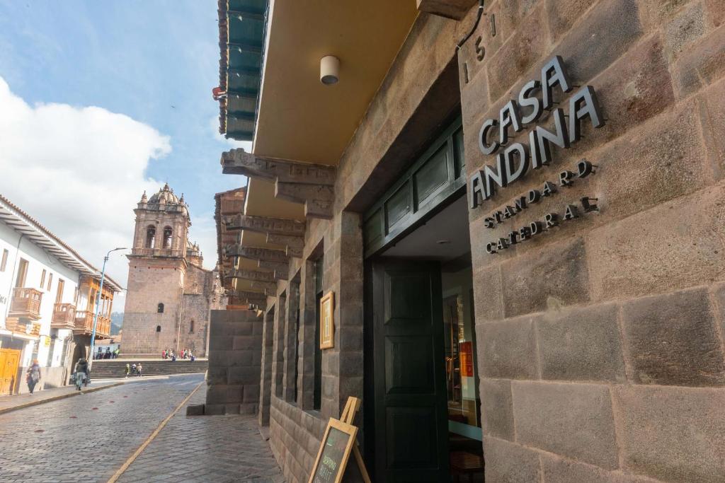 a building with a sign on the side of a street at Casa Andina Standard Cusco Catedral in Cusco
