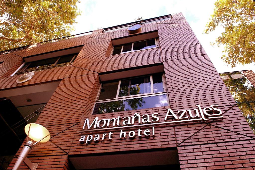a building with a sign on the side of it at Montañas Azules Apart Hotel in Mendoza