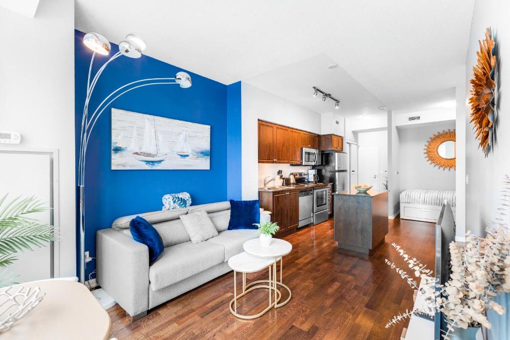 een woonkamer met een bank en een tafel bij AOC Suites - High-Rise Condo - City View in Toronto