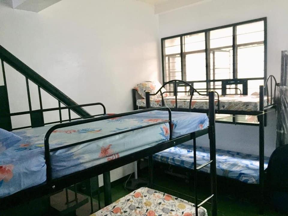 a room with three bunk beds and a window at C&CHappyStayPhilippines Metropolitan Tower, 1746 A Mabini st, Malate Manila, Unit # 1104 in Manila