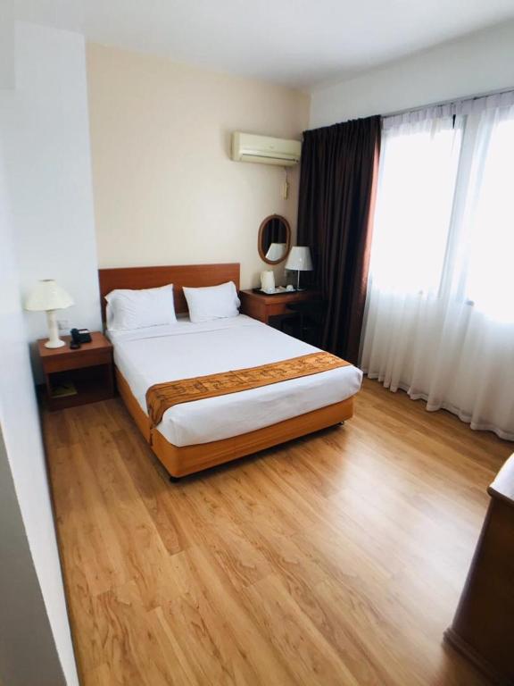 Postel nebo postele na pokoji v ubytování Kawan Hotel