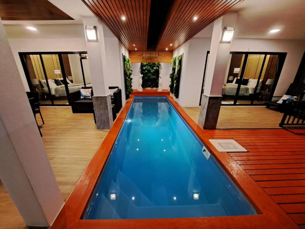 a swimming pool in the middle of a hotel lobby at The Chic Pool Villa in Nai Yang Beach
