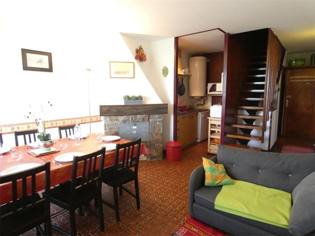 a living room with a table and a dining room at Appartement Saint-Lary-Soulan, 3 pièces, 9 personnes - FR-1-457-157 in Saint-Lary-Soulan