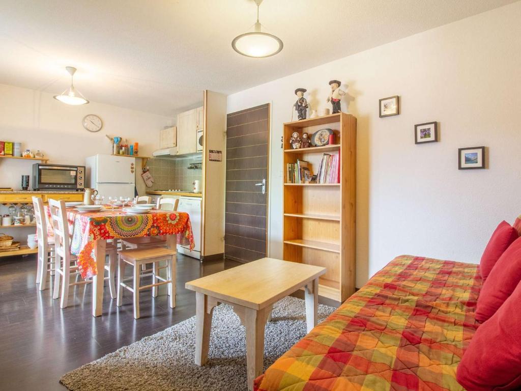 a living room and kitchen with a table and chairs at Agréable T2 Cabine avec Piscine, Balcon et WiFi à Luz-Saint-Sauveur - FR-1-402-116 in Luz-Saint-Sauveur