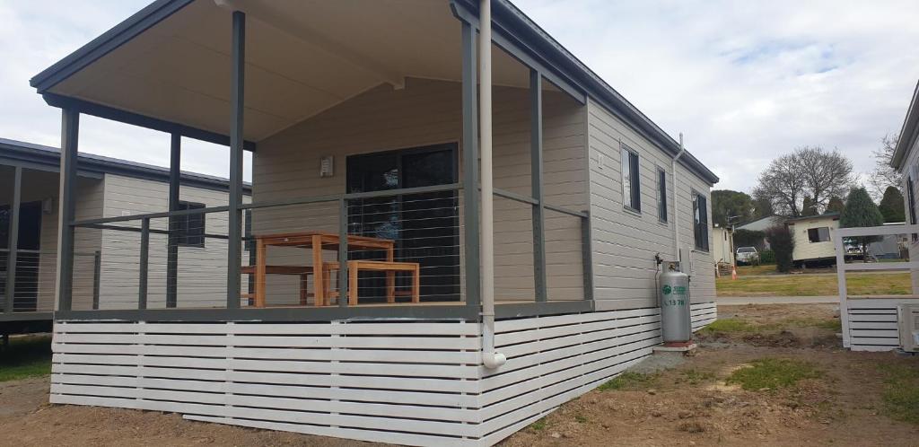 a screened in porch on a tiny house at Moss Vale Village Park in Moss Vale