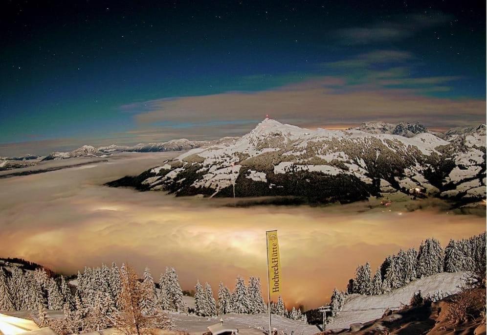 a view of a mountain with snow on it at Hocheckhuette On Top of the Kitzbuehel Hahnenkamm Mountain in Kitzbühel