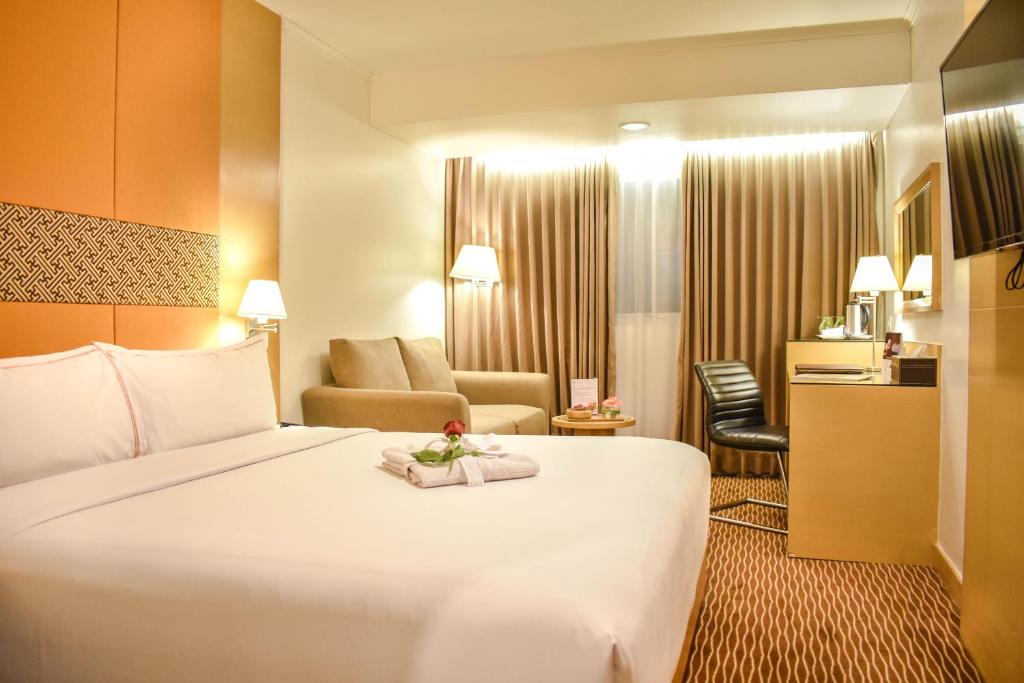 Letto o letti in una camera di All Sedayu Hotel Kelapa Gading