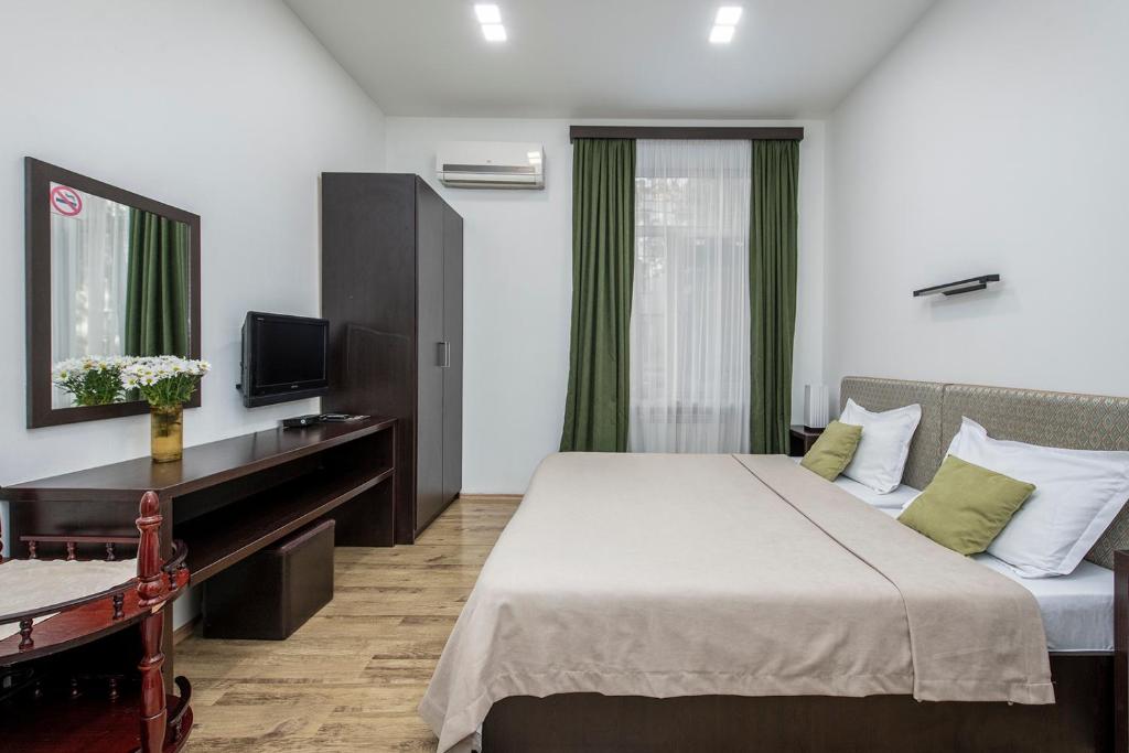Postel nebo postele na pokoji v ubytování Apart Hotel GH