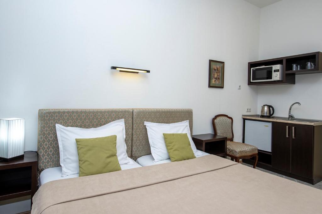 Postel nebo postele na pokoji v ubytování Apart Hotel GH