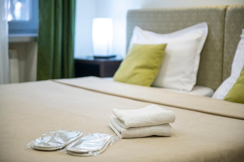Postel nebo postele na pokoji v ubytování Apart Hotel GH