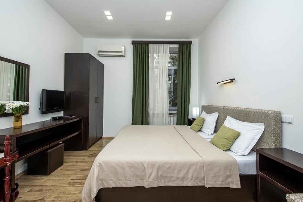 Postel nebo postele na pokoji v ubytování Apart Hotel GH
