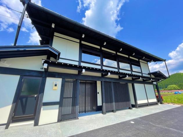 a black and white building with a lot of windows at Kabuto Villas ー古民家ステイー 