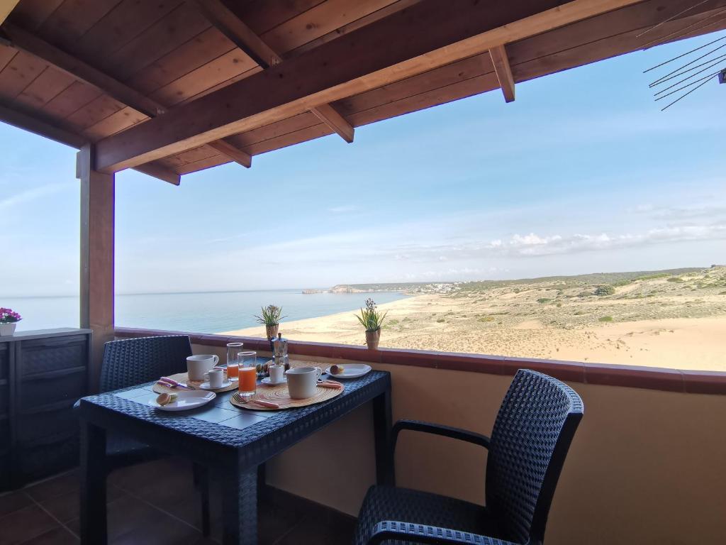 a table and chairs with a view of the beach at SARDEGNA in Torre Dei Corsari