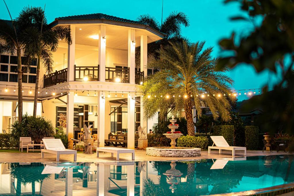 a large house with a pool in front of it at ทรายทอง รีสอร์ท in Ban Pru Yai