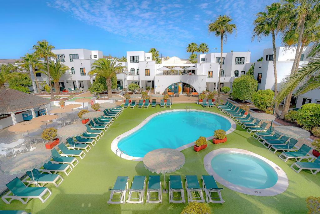 an aerial view of a resort with a pool and chairs at Nazaret Sol in Costa Teguise