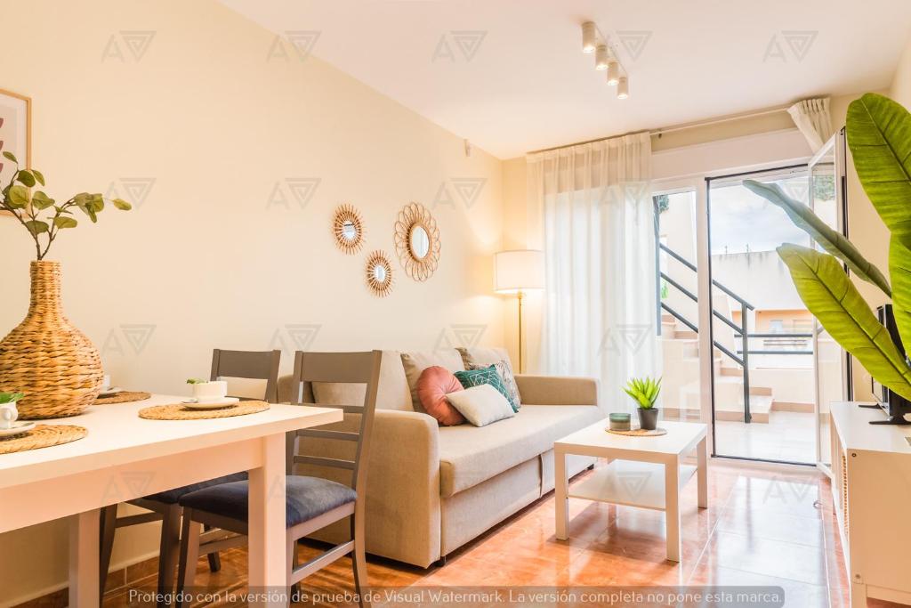 a living room with a couch and a table at Duplex PARAISO VERA Playa PISCINA PRIVADA in Vera