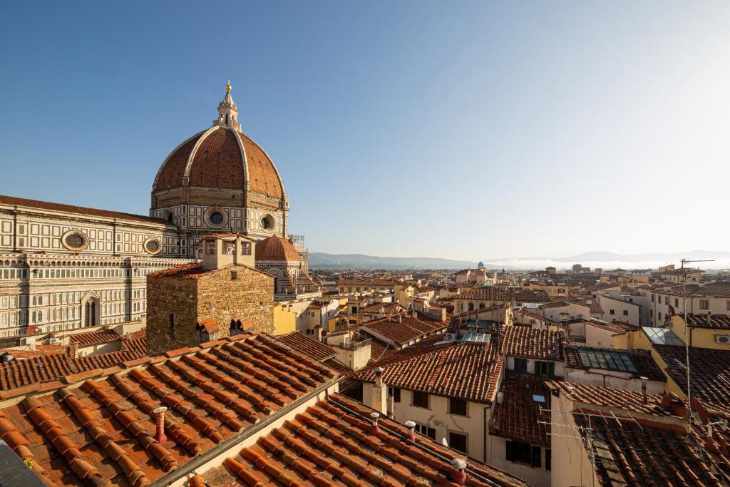 a view of a city with a cathedral and roofs at Hotel Villani in Florence