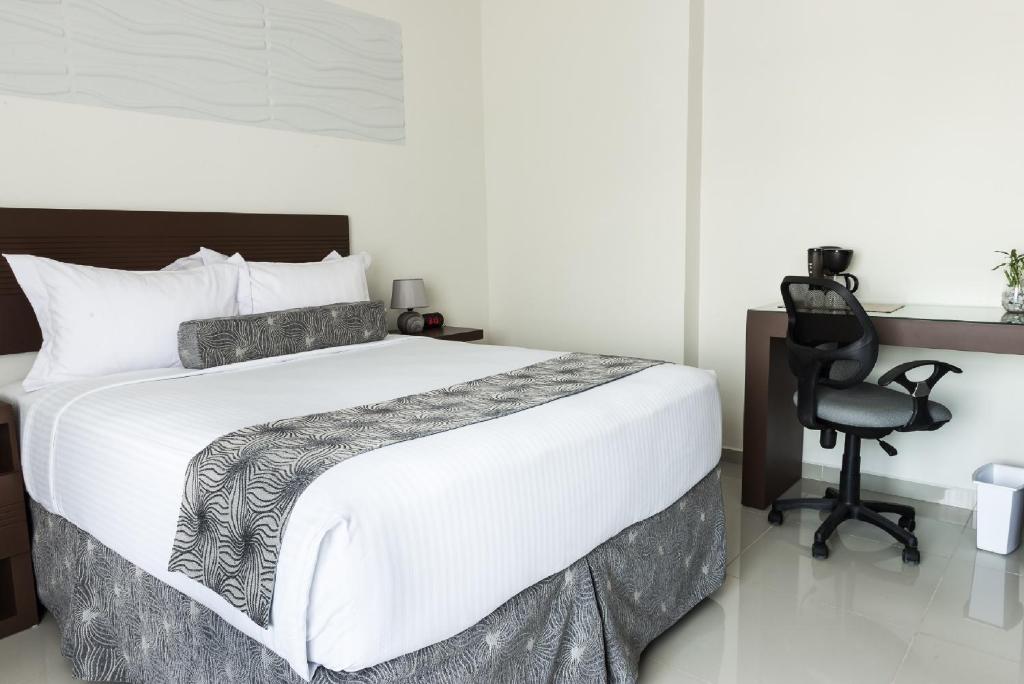 Postel nebo postele na pokoji v ubytování Hotel Latitud 15