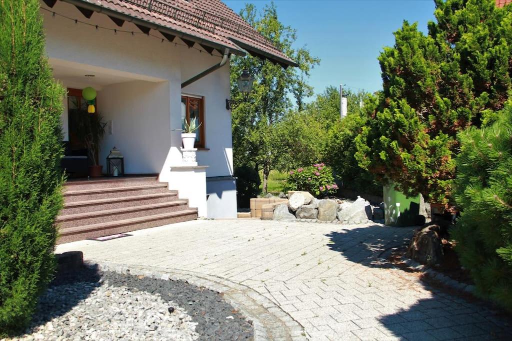 a house with a stone walkway in front of it at Familienfreundliche FeWo in Offenburg