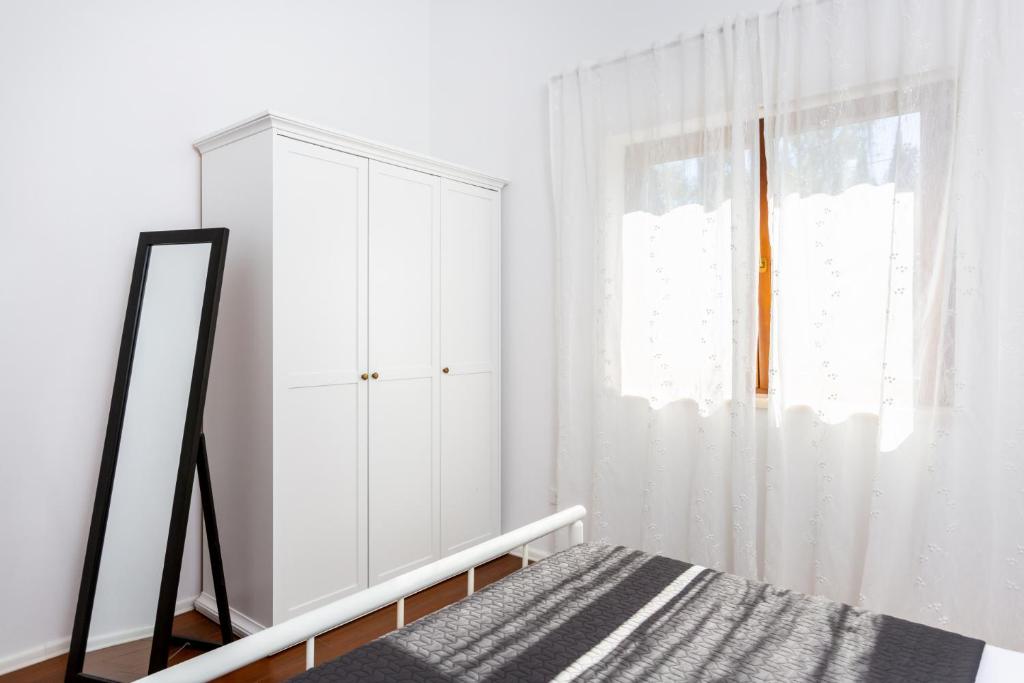 Łóżko lub łóżka w pokoju w obiekcie Villa Vignola