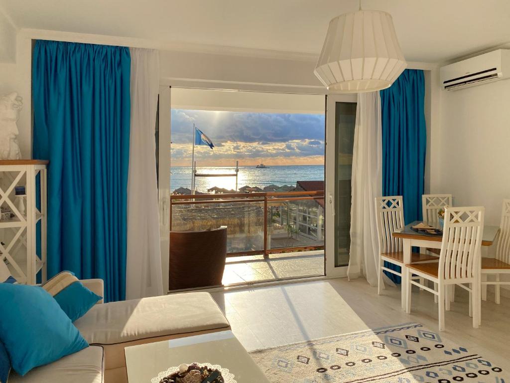 a living room with a view of the ocean at Boutique Citadel in Eforie Nord