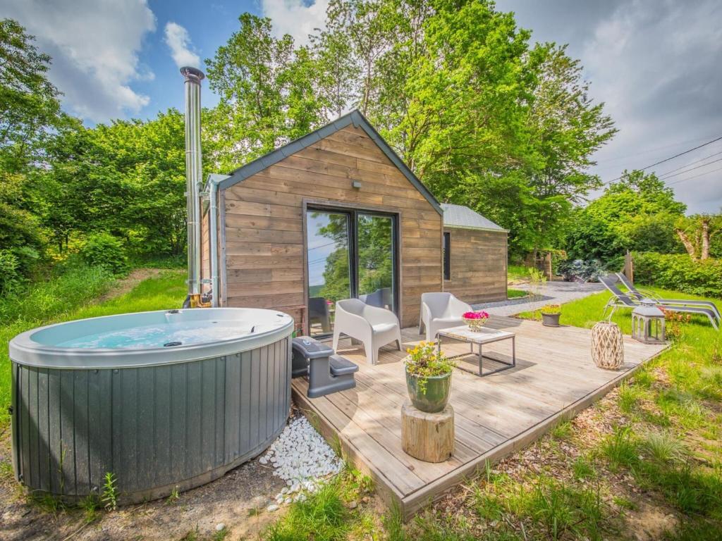 a tiny house with a hot tub in the yard at Holiday home 'Be Chalet' in the heart of nature in Ferrieres in Ferrières