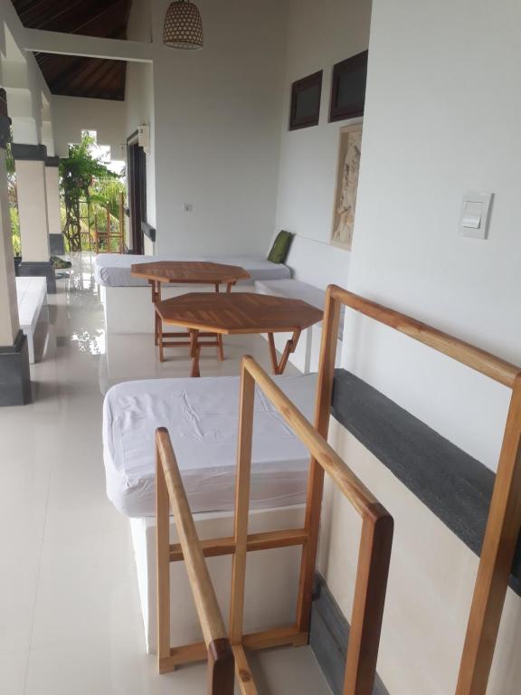a room with several beds and tables in it at Anda Amed Villas & Spa in Amed