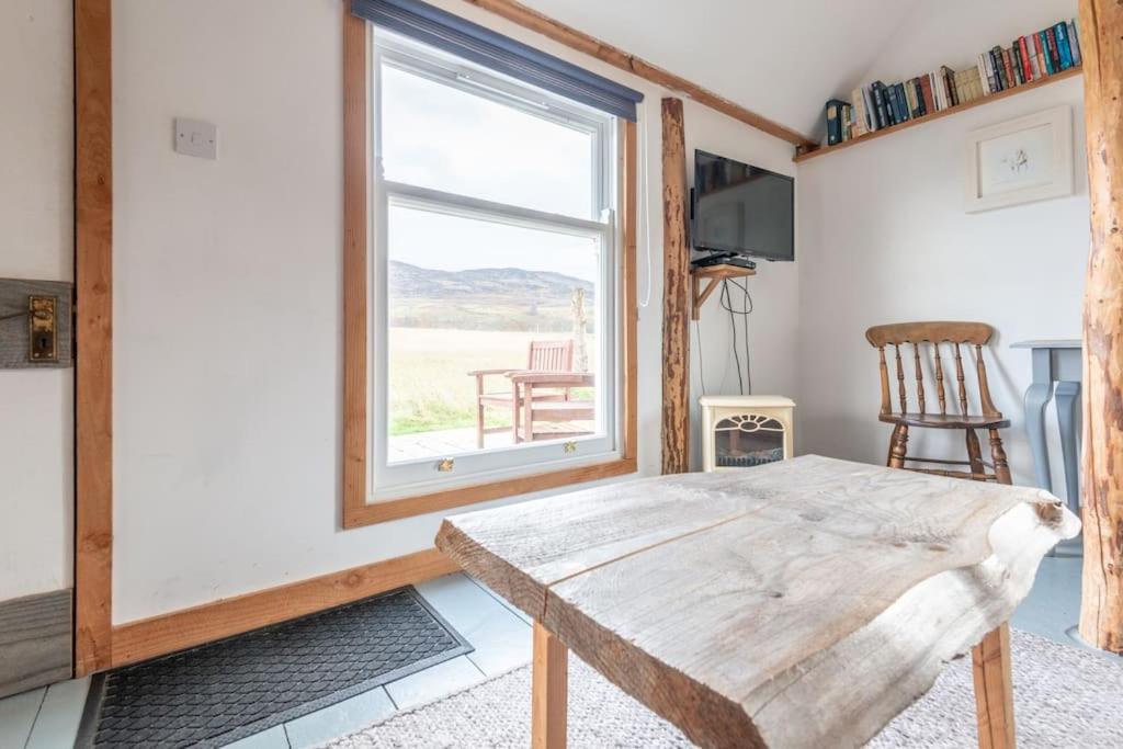 a room with a wooden table and a window at The Field House in Fort Augustus