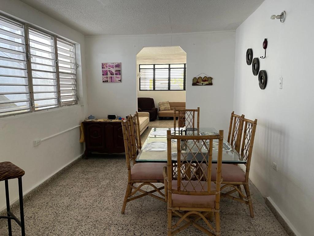 a dining room and living room with a table and chairs at Guanica Malecon Bay House in a comfortable and quiet place in Guanica