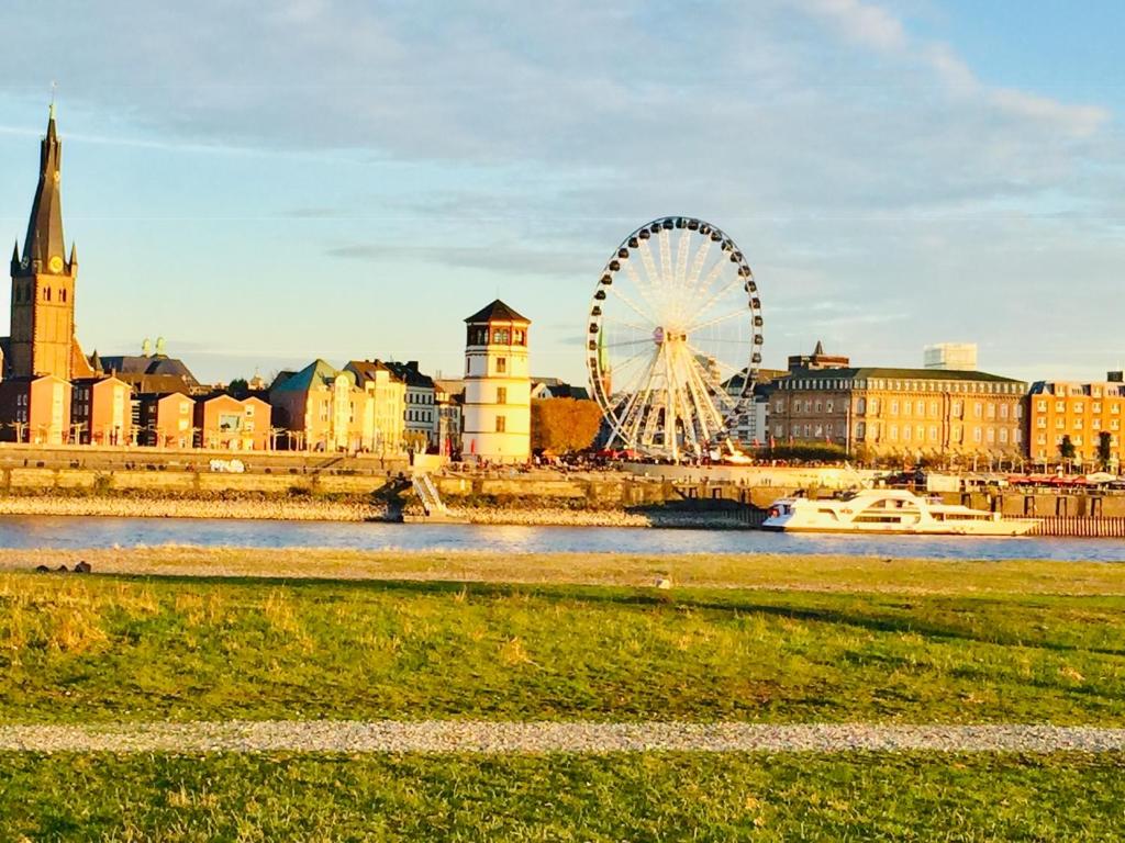 une roue ferris au milieu d'une ville dans l'établissement Apartment 120 qm -3 Schlafzimmer-2 Bäder- für 8 Gäste, à Düsseldorf