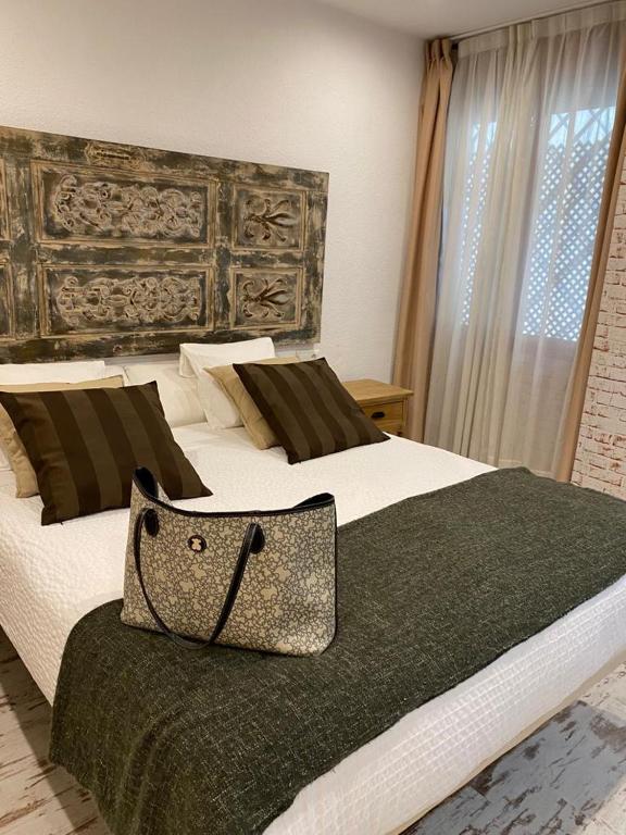 Posteľ alebo postele v izbe v ubytovaní Apartamentos Sevilla Palace