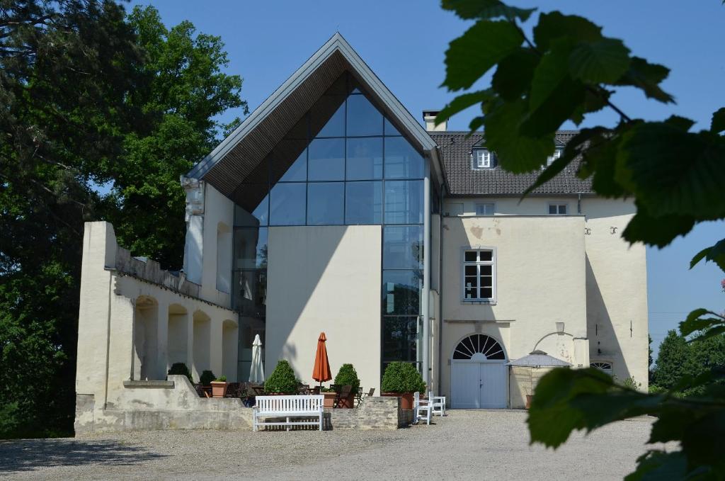 ein großes weißes Gebäude mit einem großen Fenster in der Unterkunft Burg Boetzelaer in Kalkar