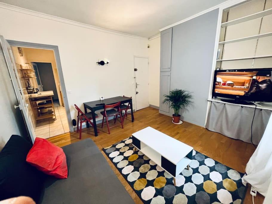 a living room with a couch and a table at Descent Unit in Fontainebleau in Fontainebleau