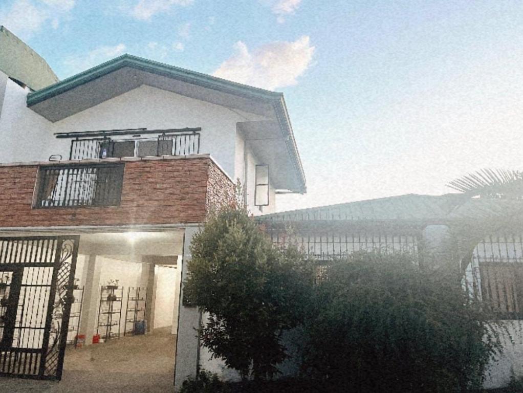 a large white house with a balcony on top of it at 4 bedroom 2 bath house in Angeles