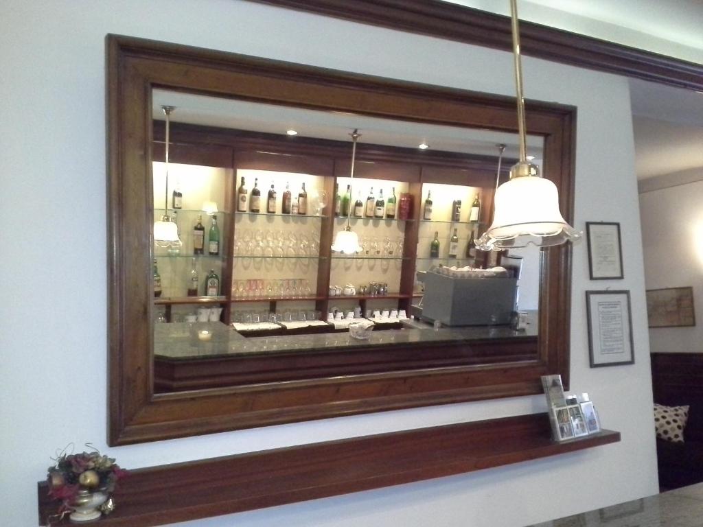 a mirror on the wall of a liquor store at Albergo Italia di Nardi Renzo & C Snc in Poggibonsi