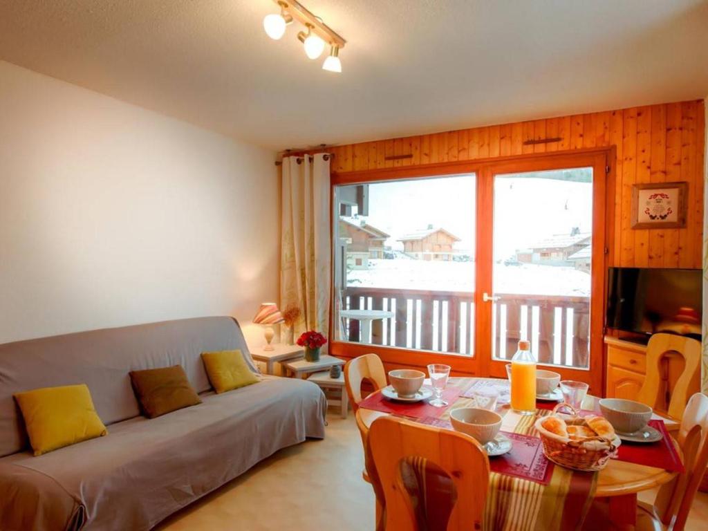 a living room with a couch and a table at Appartement Le Grand-Bornand, 2 pièces, 6 personnes - FR-1-241-16 in Le Grand-Bornand