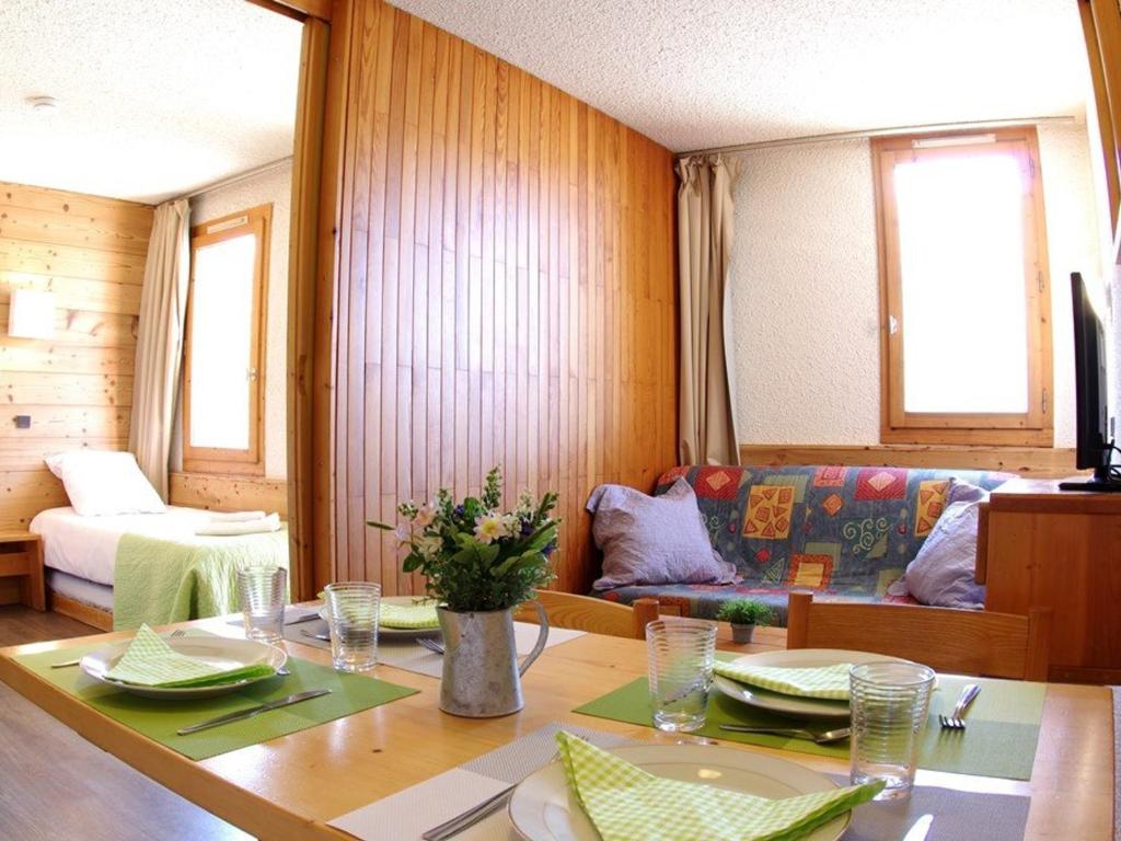 a living room with a table and a couch at Appartement Valmorel, 1 pièce, 4 personnes - FR-1-291-748 in Valmorel