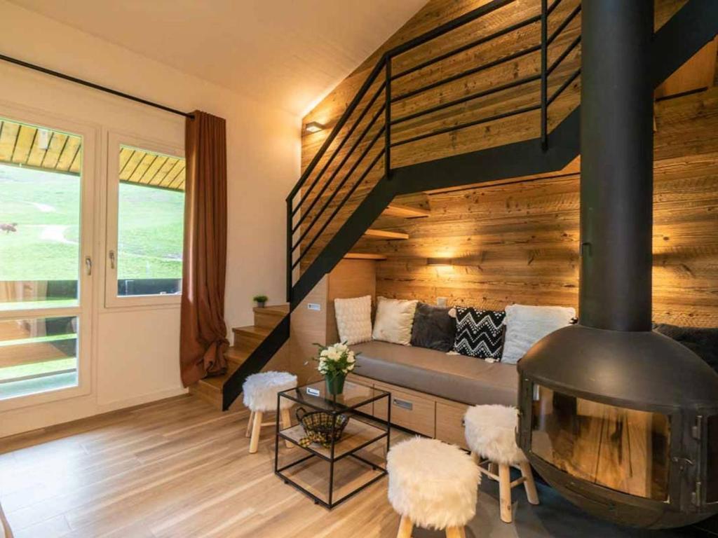 a living room with a couch and a fireplace at Appartement Valmorel, 3 pièces, 7 personnes - FR-1-291-743 in Valmorel
